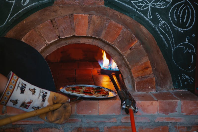 Fresh pizza preparation for catering at Green lantern pizza